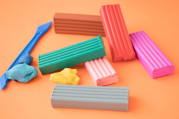 colored plasticine on on orange background