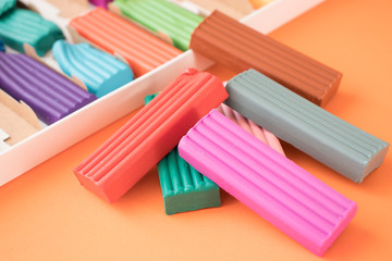 colored plasticine on on orange background