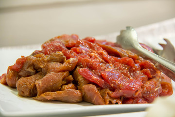  slice meat on plate for cooking