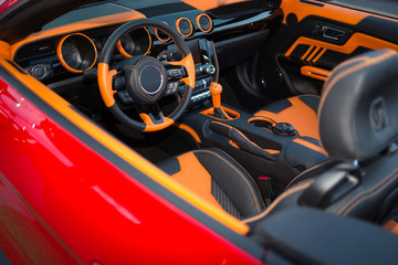 Sports car interior with orange accents.