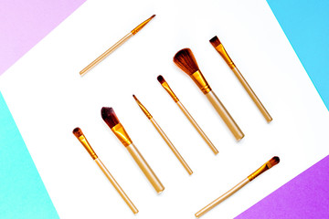 cosmetic set with brushes on woman table background top view mockup