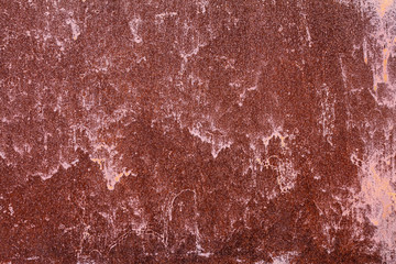 Old painted metal surface. Rusty metal, peeling paint, red tones. Worn metallic iron panel.