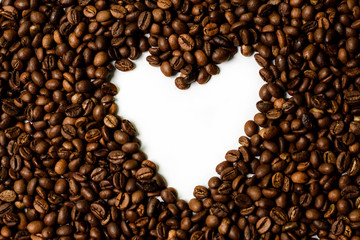 Roasted brown coffee beans scattered on white table with a lot copy space for text. Flat lay composition. Close up, top view, background. 