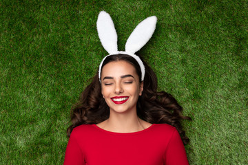 Dreaming young woman in bunny ears 