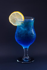 blue cocktail with lemon and ice