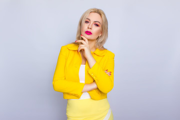 Blonde business woman in yellow suit