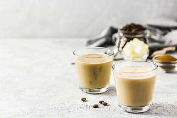 Keto bulletproof coffee in glasses. Selective focus, space for text.