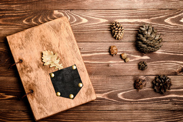 Wooden notepad on wooden background. Forest decoration.