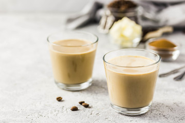 Cinnamon bulletproof coffee in glasses. Selective focus, space for text.