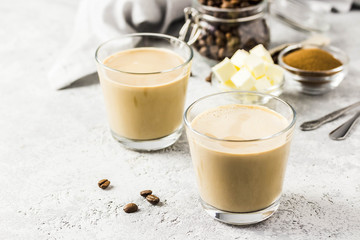 Cinnamon bulletproof coffee in glasses. Selective focus, space for text.