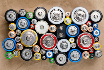 Used Alkaline batteries on recycled paper toxic waste recycling and ecology issues concept...