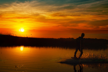 Fototapeta premium Wakeboarder making tricks on sunset