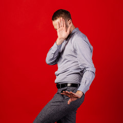 Man doing stop gesture with sad and fear expression. over red background. people and emotion...