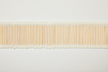 top view of cotton ear sticks laid out horizontally on white background