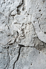 Background from a concrete wall with large cracks close up