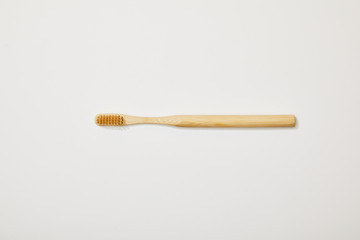 top view of bamboo toothbrush on white background