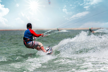 Kite surfing in waves. Splash water. Extreme summer sport at sunny day