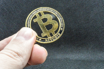 Bitcoin digital currency, coins close up on a black background
