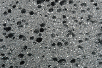 Beautiful black foam rubber texture with a hole