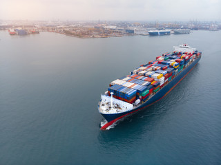 Aerial of cargo ship carrying container and running for export and import goods  from  cargo yard...