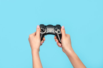 Crop woman playing game with gamepad 