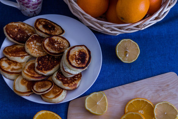 Fototapeta na wymiar Pancakes on a blue tablecloth