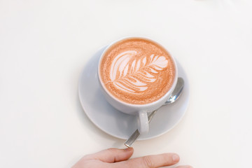 Big white cup of mokka coffee on wooden white table