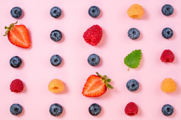 Pattern of berries on pink background. Flat lay mix summer berries background. Creative minimalism....