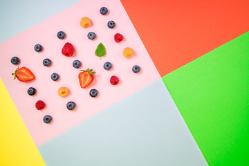 Trendy colorful summer background. Creative background of summer berries. Flat lay. Top view
