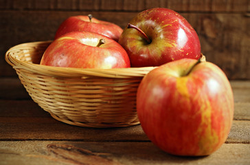 Basket of red apples on wood
