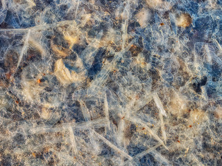 Fototapeta na wymiar Ice crystals on a stony wet ground on a clear morning
