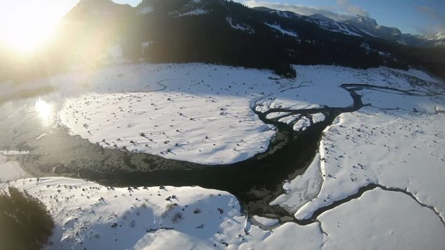 Epic Frozen Lake Aerial Reveal of Snowy Cascade Mountain Range