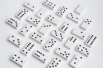 Domino pieces are neatly laid out on a white surface