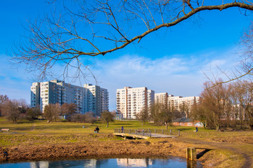 Warsaw, Poland - Dolina Sluzewiecka valley and public park along the Potok Sluzewiecki creek with Mokotow and Sluzew nad Dolinka districts residential architecture in early spring season.