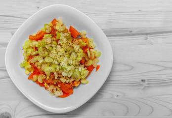vitamin salad of tomatoes, celery stalks and onions seasoned with black pepper
