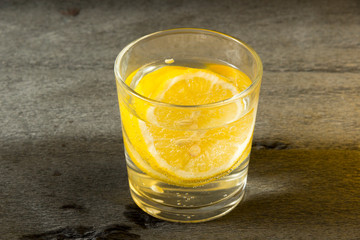 A glass with lemon wedges and carbonated water