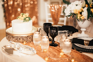 Serving a Banquet table in black and gold color. Wedding decor