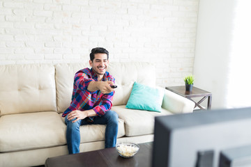 Obraz premium Man Watching TV During His Leisure Time