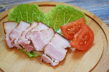 Smoked bacon, sliced on a wooden Board. Smoked bacon.