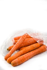 Carrots in plastic bag isolated on white