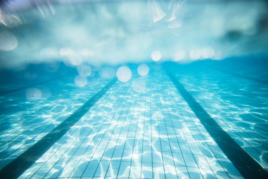 Wide angle underwater photo inside an olympic sized swimming pool with racing lanes