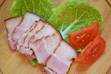 Smoked bacon, sliced on a wooden Board. Smoked bacon.