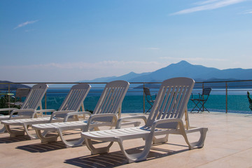 pool chairs overlooking ocean in Greece