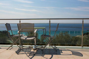 chairs and table overlooking ocean