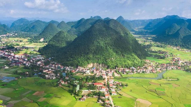 serene village time lapse in valley with paddy field all around at Bac Son, Long Son, Vietnam , Zoom out