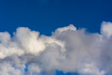 Thick white clouds against the blue sky. Close-up with copy space