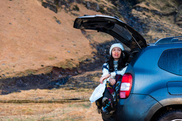 Fototapeta na wymiar Female traveler enjoying Iceland view from the car
