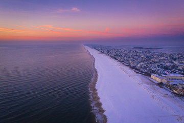 Long Beach Island at sunrise in the winter with snow on the beach