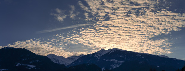 silhouette mountain landscape winter evening with fantastic cloudscape