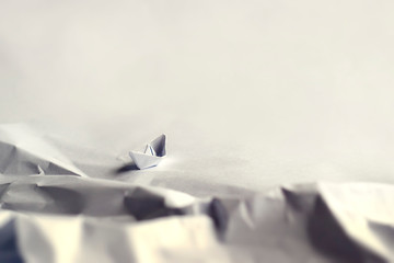 Origami concept. Boat at a rocky bay